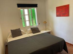a bedroom with a large bed with a window at Casa Calderón in Marbella