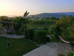 a view of a garden with trees and a stone pathway at Calla Retreat in Vezenkovo