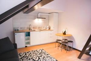 a kitchen with a table and chairs in a room at Aizpuri West View in Nīca