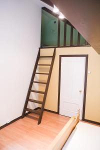 a staircase in a room with a door at Aizpuri West View in Nīca
