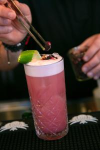 a drink with a lime on top of a table at Aloft Strasbourg Etoile in Strasbourg