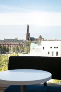 d'une table blanche et d'une vue sur la ville. dans l'établissement Aloft Strasbourg Etoile, à Strasbourg