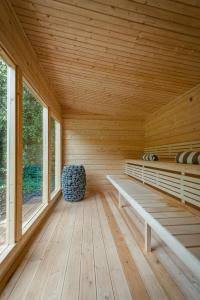 a sauna with a bench in a wooden room at Manoir de Laroque Delprat in Autoire