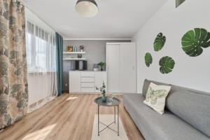 a living room with a couch and a table at Studio with Sky Tower View Wrocław by Renters in Wrocław