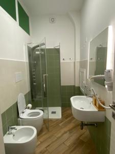 a bathroom with two sinks and a toilet and a shower at Casa Gina e Pietro in Ustica