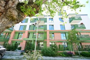 an apartment building with a green and white at FLH - The Lake Home - Apt 33 in Sibiu