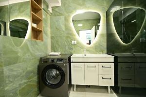 a bathroom with a washing machine and a sink at FLH - The Lake Home - Apt 33 in Sibiu