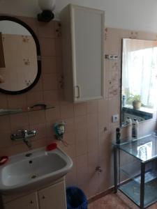 a bathroom with a sink and a mirror at U Sowy in Kołobrzeg