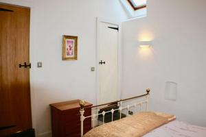 a bedroom with a bed and a light on the wall at Mount Barn in Newcastle Emlyn