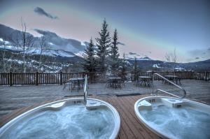 a hot tub on a deck with a table and chairs at The Lodge at Breckenridge in Breckenridge
