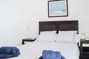 une chambre avec un lit recouvert de serviettes bleues dans l'établissement Villa Opal, à Cala'n Bosch 17 autres photos