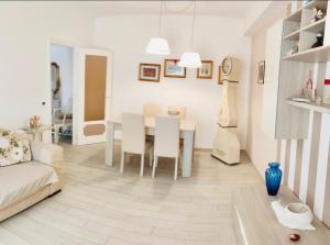 a living room with a table and a dining room at Relax Venezia in Ladispoli