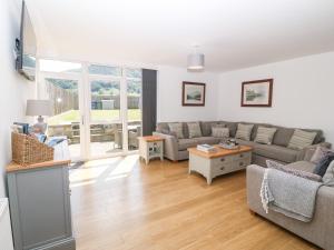 a living room with a couch and a table at 3 Pensyflog Barns in Porthmadog