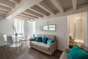 a living room with a couch and a table at Il Balcone sul Lago by Quokka 360 - historic lakeside flat in Morcote in Morcote