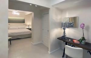 a bedroom with a bed and a table and a desk at Taormina Sunrise in Taormina