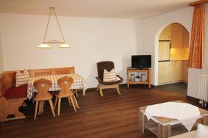 a living room with a bed and chairs and a table at Residenza Lagrev 2 Zimmerwohnung Nr 005 - Typ 21A - Hochparterre - Süd in Sils Maria