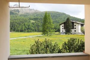 a view from a window of a house in a field at Residenza Lagrev 2 Zimmerwohnung Nr 005 - Typ 21A - Hochparterre - Süd in Sils Maria