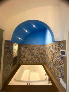 La salle de bains est pourvue d'une baignoire avec un plafond bleu. dans l'établissement San Nicola Suite & mini apartment, à Sorrente