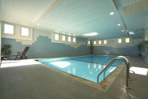 a large indoor swimming pool in a building at Residenza Lagrev 1 Zimmerwohnung Nr 128 - Typ 12B - 1 Etage - Ost in Sils Maria