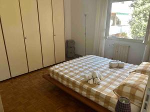 a bedroom with a bed with two stuffed animals on it at Appartamento Accademia in Livorno