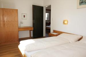 Postel nebo postele na pokoji v ubytování Residenza Lagrev 2 Zimmerwohnung Nr 112 - Typ 21B - 1 Etage - Süd