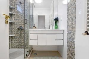 a white bathroom with a sink and a shower at Casa Lomba in Colares
