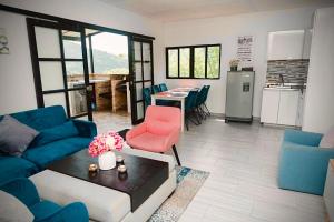 a living room with a blue couch and a red chair at FINCA LAS MARÍAS 2 in Vergara