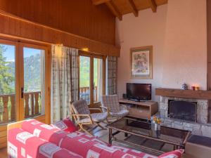 a living room with a couch and a fireplace at Apartment Baudrier A28 by Interhome in Verbier