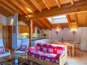 a living room with a couch and chairs and a kitchen at Apartment Baudrier A28 by Interhome in Verbier