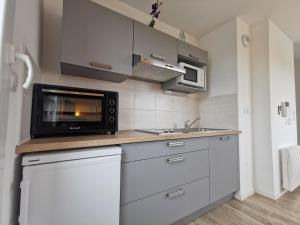 a small kitchen with a microwave and a sink at Studio Apsara by Interhome in Saint Malo