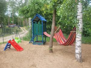 a playground with two hammocks in the sand at Lusesita in Nowy Jasiniec