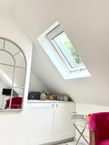 a room with a skylight and a chair and a mirror at The Nest in Rake