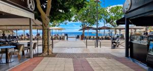 a street with tables and chairs and the ocean at Appartement en bord de mer 3 in Banyuls-sur-Mer