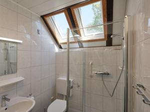 baño con aseo y lavabo y ventana en Holiday Home Am Sternberg 97 by Interhome, en Frankenau
