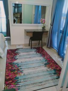 a living room with a rug with flowers on it at Qilala DualView by The Shore in Kota Kinabalu