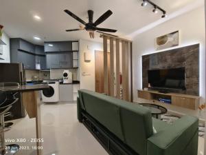 a living room with a couch and a ceiling fan at Qilala DualView by The Shore in Kota Kinabalu