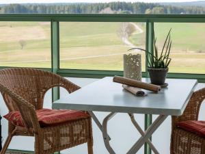 a table and chairs with a view of a field at Apartment F 32 by Interhome in Dittishausen