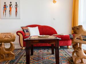 a living room with a red couch and a table at Apartment F 32 by Interhome in Dittishausen