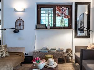 a living room with a couch and a bird cage on the wall at Villa Hjort by Interhome in Itri +26 photos