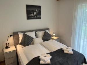 a bedroom with a bed with two towels on it at Apartment Lechner by Interhome in Mittersill