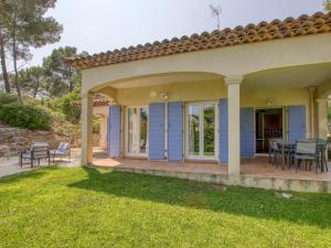 a blue house with a patio and lawn at Villa Le Puit des Oliviers I by Interhome in La Cadière-dʼAzur