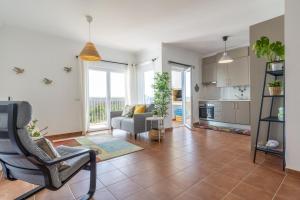 a living room with a couch and a table at Beach & Nature Apartment - 2bedroom apt in Aljezur in Aljezur