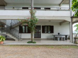 a building with a staircase and a table with a plant at Apartment Rosa Alba by Interhome in Bolsena
