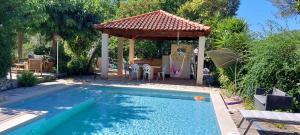 a swimming pool in a backyard with a gazebo at Villa Novella in Le Beausset