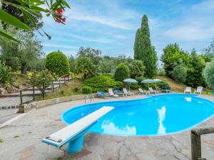 a swimming pool with a slide in the middle at Holiday Home San Lazzaro by Interhome in Montevettolini