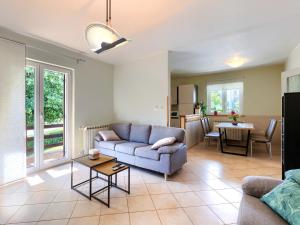 a living room with a couch and a table at Holiday Home Carlo by Interhome in Pićan
