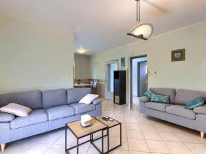 a living room with two couches and a table at Holiday Home Carlo by Interhome in Pićan