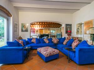 a living room with blue couches and a table at Holiday Home Tenuta San Lazzaro by Interhome in Montevettolini