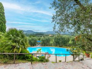 a swimming pool in a garden with a view at Holiday Home Tenuta San Lazzaro by Interhome in Montevettolini