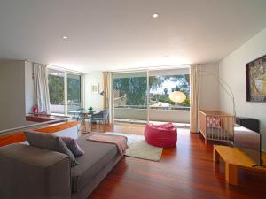 een woonkamer met een bank en een groot raam bij Holiday Home Villa Golf - PMO115 by Interhome in Portimão